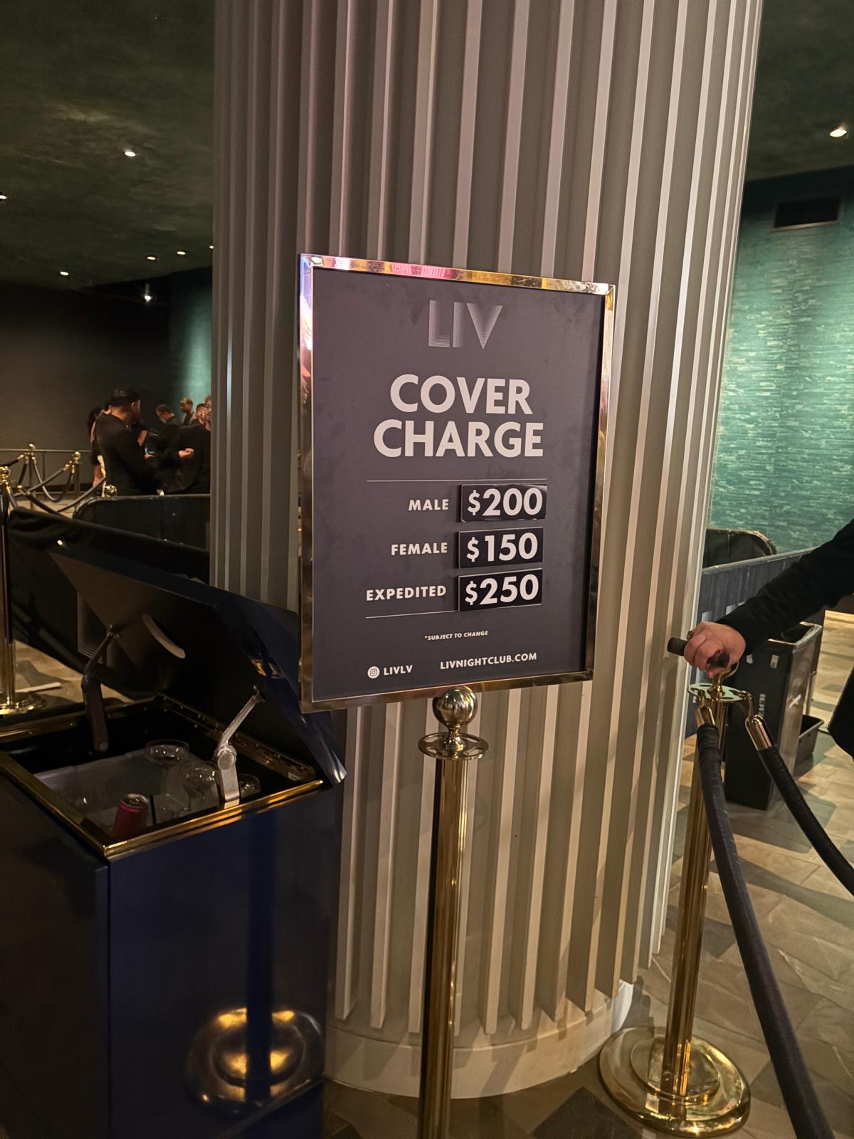 LIV nightclub cover charge sign showing 200 dollars for men, 150 dollars for women, and 250 dollars expedited